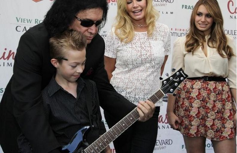 Landen Shaw, 11, gets a guitar playing tip from KISS frontman Gene Simmons as girlfriend Shannon Tweed and daughter Sophie watch. Simmons and his family were at a meet and greet at the View Royal Casino.